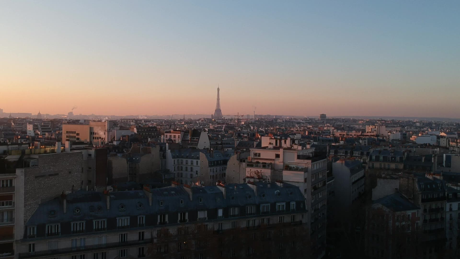 Aerial view of Paris rooftops at dusk
